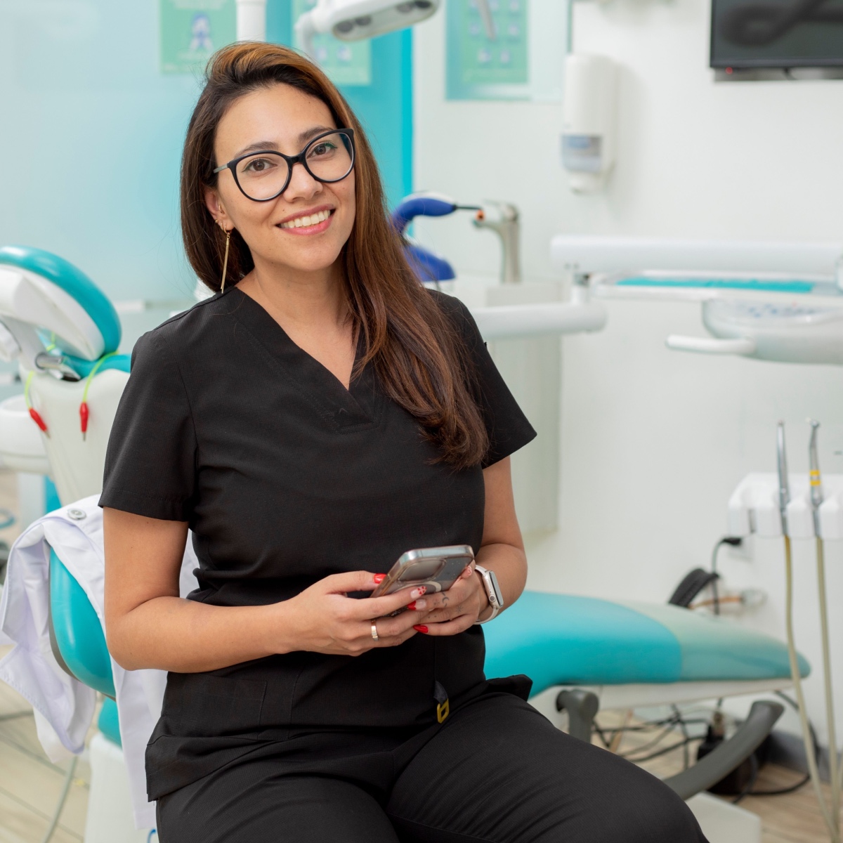 A happy dentist holding the OrthoPhoto dental recordkeeping app